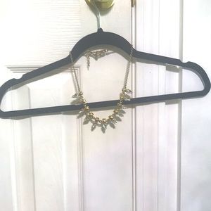 Gold chain, with studs and fun, spike-shaped stones.